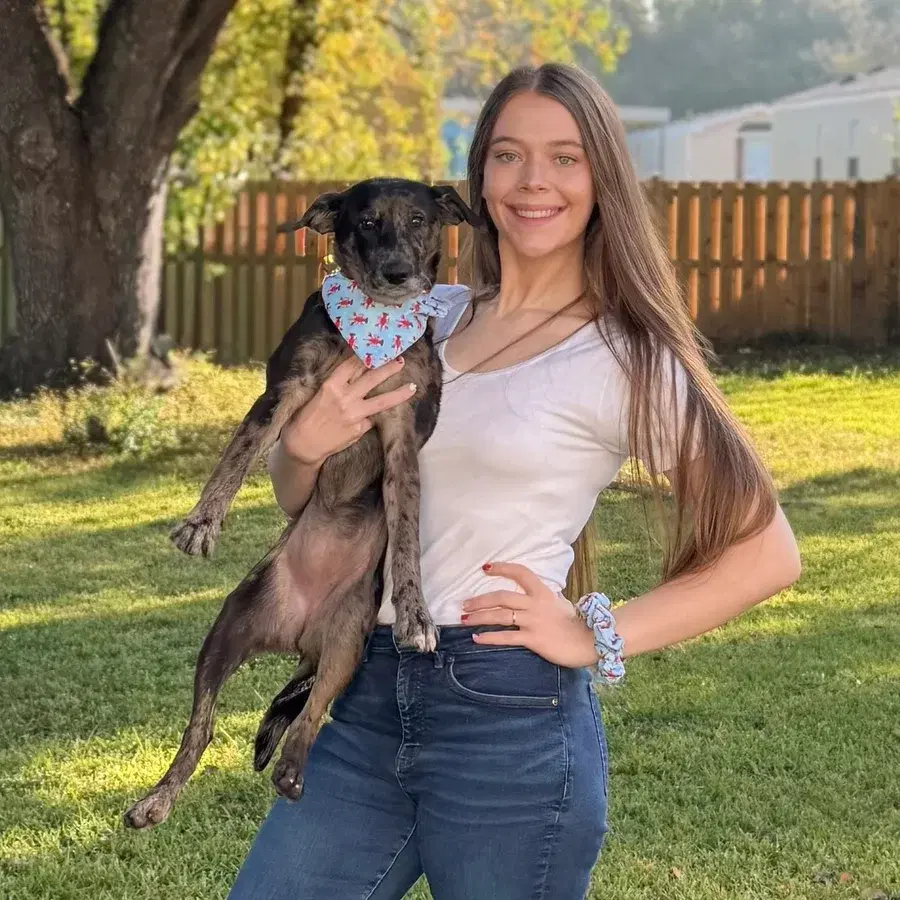 Pepper’s Pantry founder holding her dog outdoors